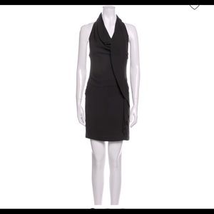 Black halter neck sheath dress with ruffle embellishment, hidden back zipper.